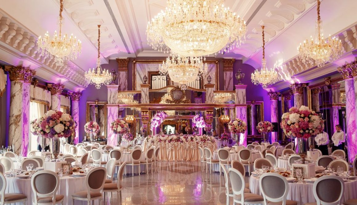 Luxurious dinner hall with large crystal chandeliers hanging fro
